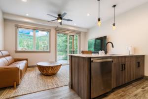 a kitchen with a counter and a sink and a couch at Romantic 1BR Getaway Across from Purgatory Resort in Durango Mountain Resort