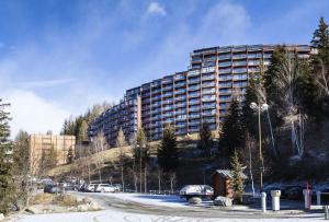 a large building on the side of a mountain at Résidence Nova 3 - Appartement 2 pièces 6 personnes proche des pistes MAE-2143 in Arc 1800 +15 photos