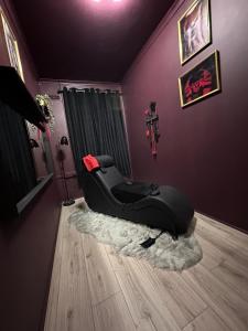 a black reclining chair in a room at Adult only, fetish retreat play space in Ifield
