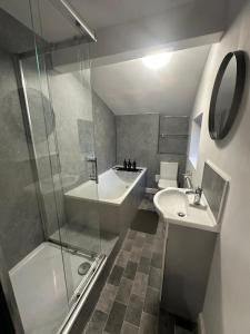a bathroom with a shower and a sink and a toilet at Adult only, fetish retreat play space in Ifield