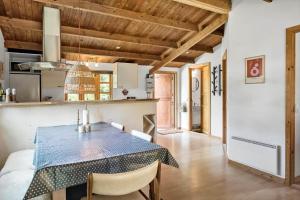 a kitchen and dining room with a blue table and chairs at M370-Vaeggerlose-Boto-Ringvej-22 in Bøtø By
