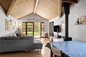 a living room with a couch and a living room with a fireplace at M370-Vaeggerlose-Boto-Ringvej-22 in Bøtø By