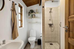 a bathroom with a toilet and a sink and a shower at M370-Vaeggerlose-Boto-Ringvej-22 in Bøtø By +13 photos