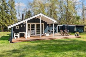 a house with a deck with chairs and a table at M370-Vaeggerlose-Boto-Ringvej-22 in Bøtø By