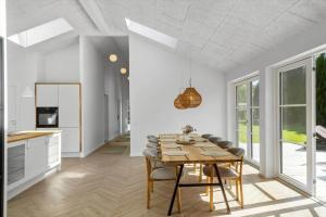 a kitchen and dining room with a table and chairs at M379-Vaeggerlose-Baeverstien-43 in Marielyst