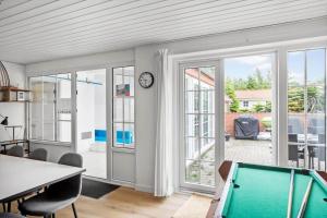 a living room with a pool table and sliding glass doors at M386-Vaeggerlose-Skarntydevej-27 in Marielyst