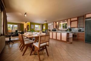 a kitchen with a table and chairs in a room at Ikigai Eden in Kavála