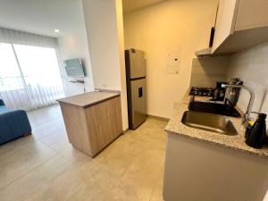 a kitchen with a stainless steel refrigerator and a sink at Apartamento familiar en Santa Marta con vista al mar y la Sierra in Santa Marta