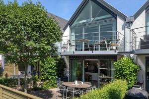 a house with a patio with a table and chairs at M384-Vaeggerlose-Marielyst-Strandvej-63-B in Marielyst