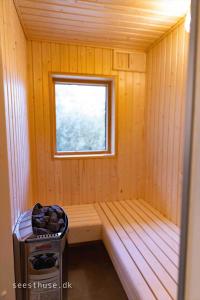 eine kleine Sauna mit einer Bank und einem Fenster in der Unterkunft M388 Væggerløse - Lotusvej 4 in Bøtø By