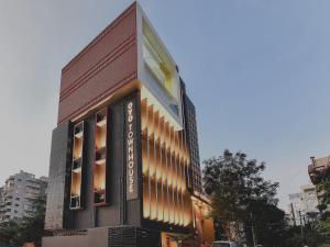 a building with a sign on the side of it at Super Townhouse Spruce Hotels Bellandur in Bengaluru