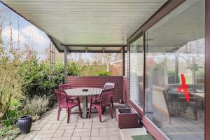 a patio with a table and chairs and a pool at SL282-Slagelse-Graspurvevej-14 in Slagelse +13 photos