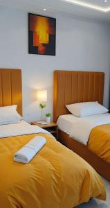 two beds sitting next to each other in a room at Moderne Appartement au plein Centre-Ville en Face Hilton & la Gare de Train TGV avec climatisation N2 in Tangier