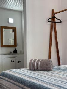 a bedroom with a bed with a mirror on the wall at CANTINHO da ARMAÇAO in Búzios
