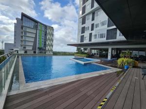 a large swimming pool in front of a building at Kozzy Loft Sitari Condominium in Bacolod