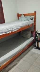 two bunk beds sitting next to each other at Dois quartos em República Estudantil in Ouro Preto