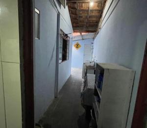 an empty hallway of a building with a sign on the wall at Dois quartos em República Estudantil in Ouro Preto