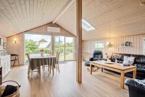 a living room with a table and a couch at SL221-Slagelse-Horvangen-2 in Slagelse
