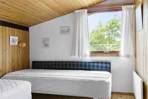 a bedroom with a bed and a window at K19057-Kalundborg-Vollerup-Vang-14 in Kalundborg