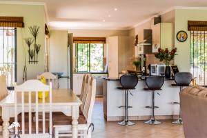 a kitchen and living room with a table and chairs at Aleah, Cathkin Estates by Euphoric Leisure in Champagne Valley