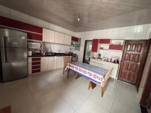 a kitchen with a table in the middle of it at Casa para COP30 in Belém