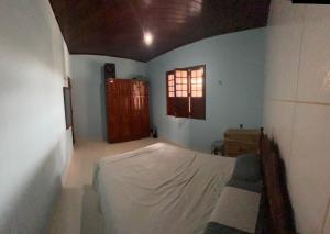 a bedroom with a bed and a window at Casa para COP30 in Belém