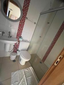 a bathroom with a shower and a toilet and a sink at Hotel Stela - A 2 min do Metrô Paraíso e Poucos Passos da Av Paulista in São Paulo +30 photos