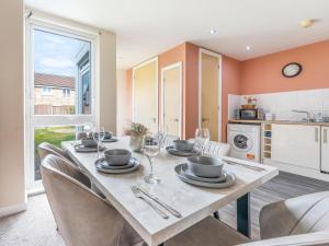 a kitchen and dining room with a table and chairs at Etihad Stadium Stay for Contractors with Free Parking & Wifi Near The City Stays in Manchester