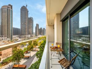 an apartment balcony with a view of the city at Stylish 1BR DOWNTOWN Apartment with BALCONY - NEXT TO DUBAI MALL & BURJ KHALIFA in Dubai