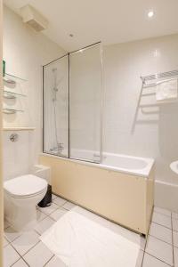 a bathroom with a shower and a toilet and a sink at Private and Cosy 1 Bed Flat By Burges Park in London