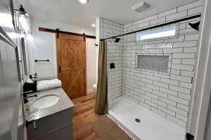 a bathroom with a tub and a sink and a shower at Private Pickleball Court, Gym, Arcade, & Hot Tub! in Dahlonega +40 photos
