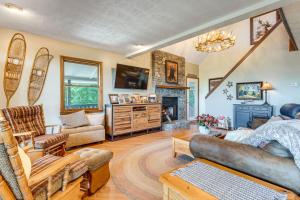 Un hombre sentado en una sala de estar con chimenea. en Decks and Lake Access Scenic North Carolina Retreat, en Old Fort