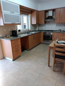 a kitchen with wooden cabinets and a table in it at AO - Tina House Ferrel in Ferrel +11 photos