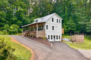a large white house on a hill with a driveway at Private Pickleball Court, Gym, Arcade, & Hot Tub! in Dahlonega