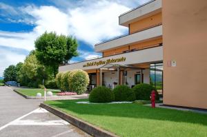 a building with a fire hydrant in front of it at Albergo Papillon in Cazzago San Martino