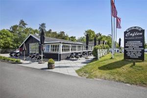 a building with chairs and a sign in front of it at SL243-Skaelskor-Hybenvej-30 in Skælskør