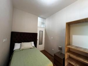 Ένα ή περισσότερα κρεβάτια σε δωμάτιο στο Departamento Cozy Home