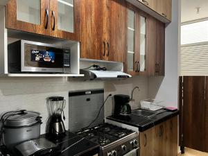 Η κουζίνα ή μικρή κουζίνα στο Departamento Cozy Home +3 φωτογραφίες