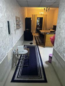a living room with a table and a laptop on it at ستوديو فرش فندقي برج تاور سي in Ajman 