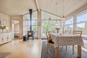 a dining room with a table and a fireplace at SL313-Slagelse-Rorhonevej-12 in Slagelse