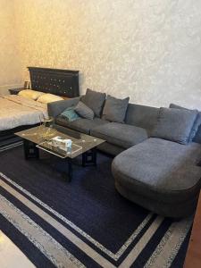 a living room with a couch and a coffee table at ستوديو فرش فندقي برج تاور سي in Ajman 