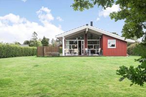 a red house with a large yard in front of it at SL313-Slagelse-Rorhonevej-12 in Slagelse