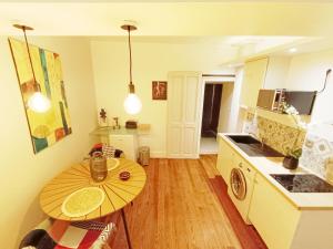 a kitchen with a wooden table and a small table in a room at Cosy campagne in Pont-sur-Seine