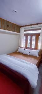 une chambre avec un lit et une fenêtre dans l'établissement Anand Niwas Homestay Bhowali near Nainital Kainchi Dham and Bhimtal, à Bhowāli