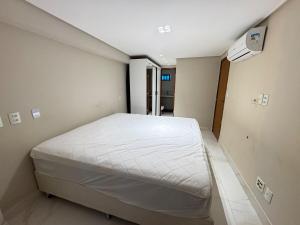 a bedroom with a white bed in a room at Luxor Tambau, the best location in João Pessoa +6 photos