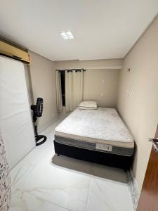 a bedroom with a bed in the corner of a room at Luxor Tambau, the best location in João Pessoa
