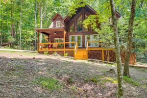 a log cabin in the woods with a yard at North Georgia Cabin with Hot Tub and Community Perks! in Jasper
