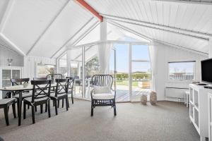 a dining room with a table and chairs and a television at SL310-Slagelse-Birkevej-49 in Slagelse