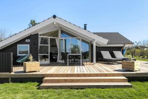 a house with a wooden deck with a table at SL310-Slagelse-Birkevej-49 in Slagelse
