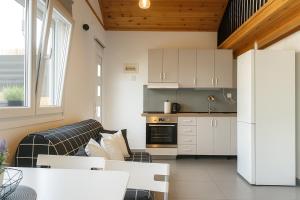 a kitchen and a living room with a couch at Casa Porto in Ierissos